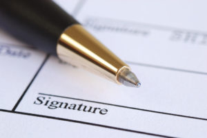 pen on a life insurance application needing a signature