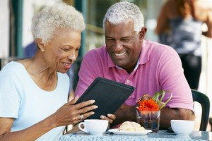 couple in their 60s researching life insurance on a tablet